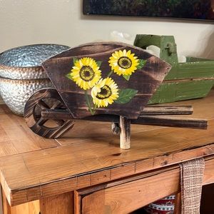 Sunflowers painted in wheelbarrow.